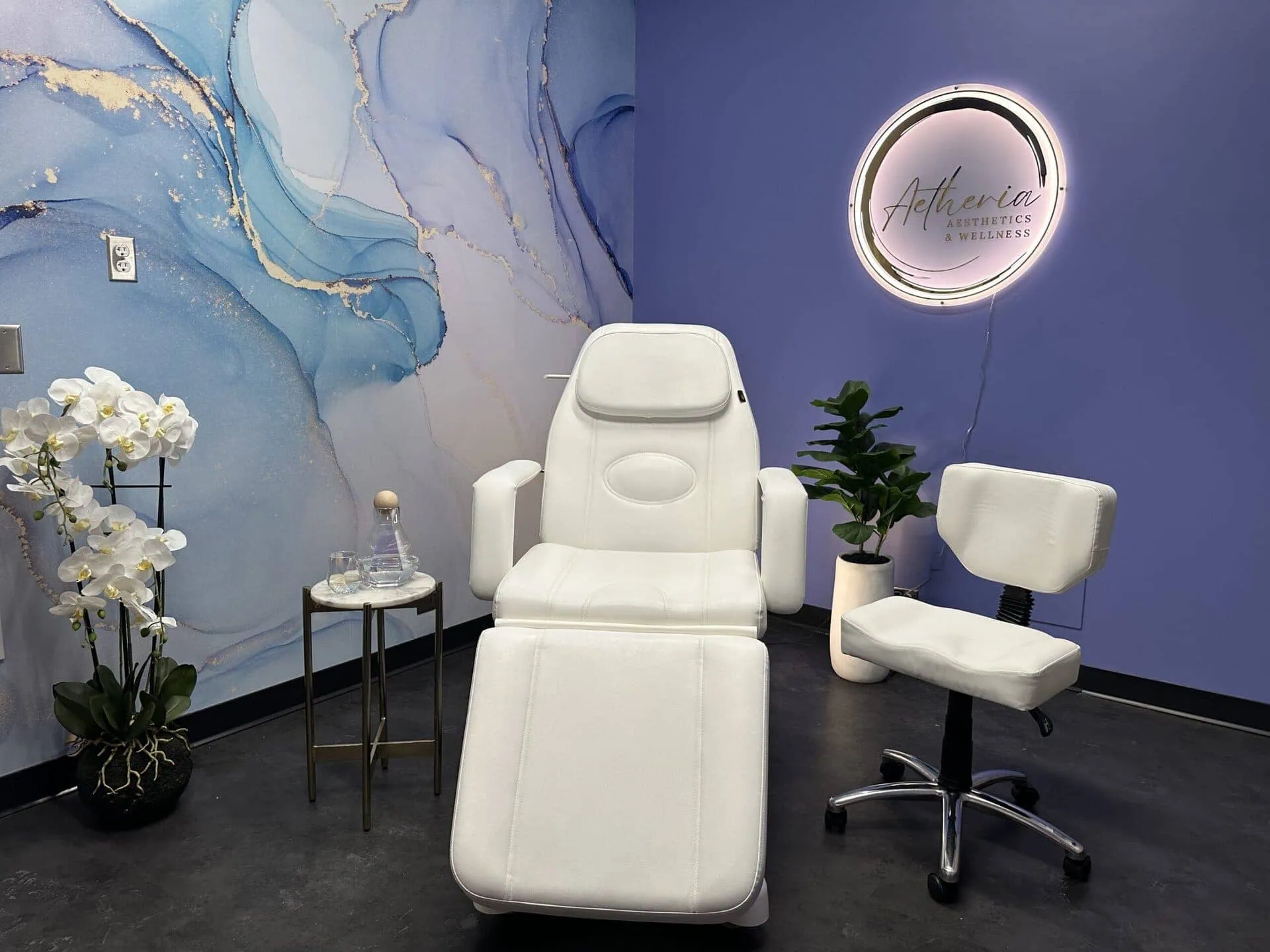 Aetheria Aesthetics & Wellness treatment area showcasing a clean, professional space with advanced equipment and a calming ambiance.