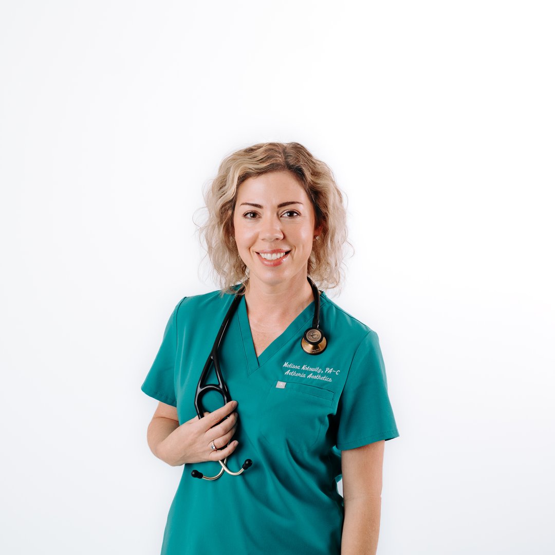 Aetheria Aesthetics & Wellness founder Melissa Kolowitz PA-C smiling in teal scrubs.